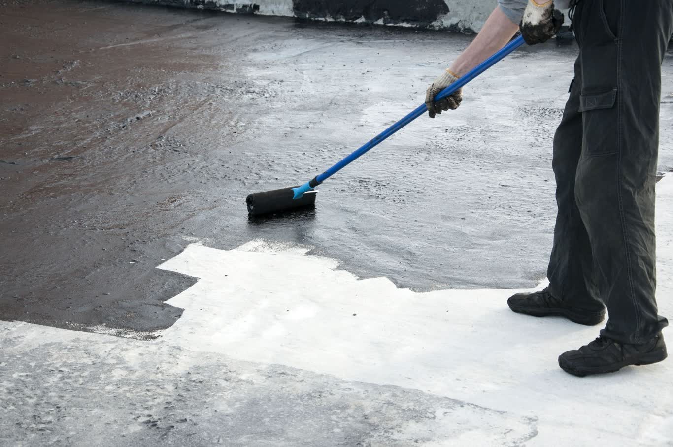 Roof coating application on commercial flat roof extending membrane life